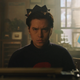 Jughead, in his trademark whoopee cap, sits at a typewriter and stares angrily at the viewer.